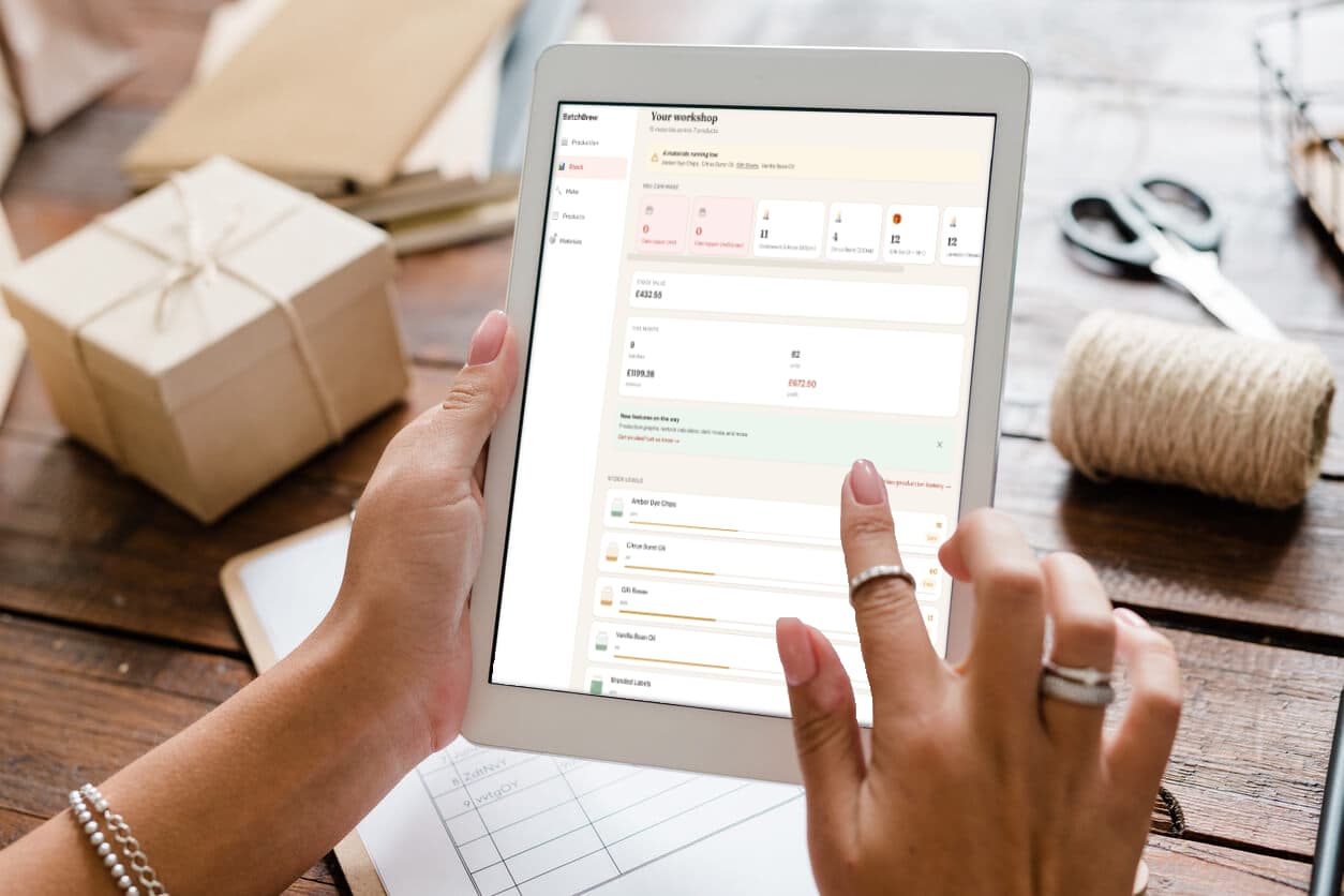 Maker reviewing stock on a tablet in their workshop